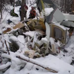 Search and Rescue workers view the Piper Malibu that crashed near Blueberry Peak.